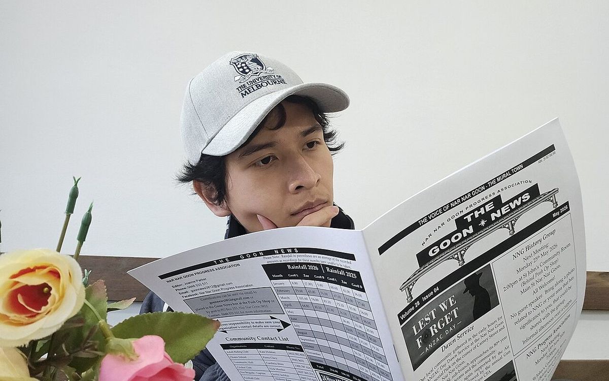 A University student reading the local newspaper, The Goon News