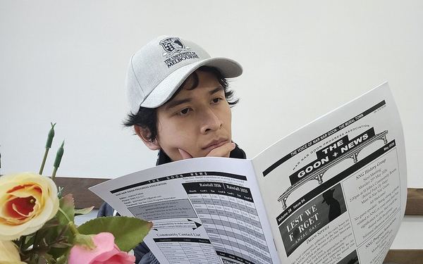 A University student reading the local newspaper, The Goon News